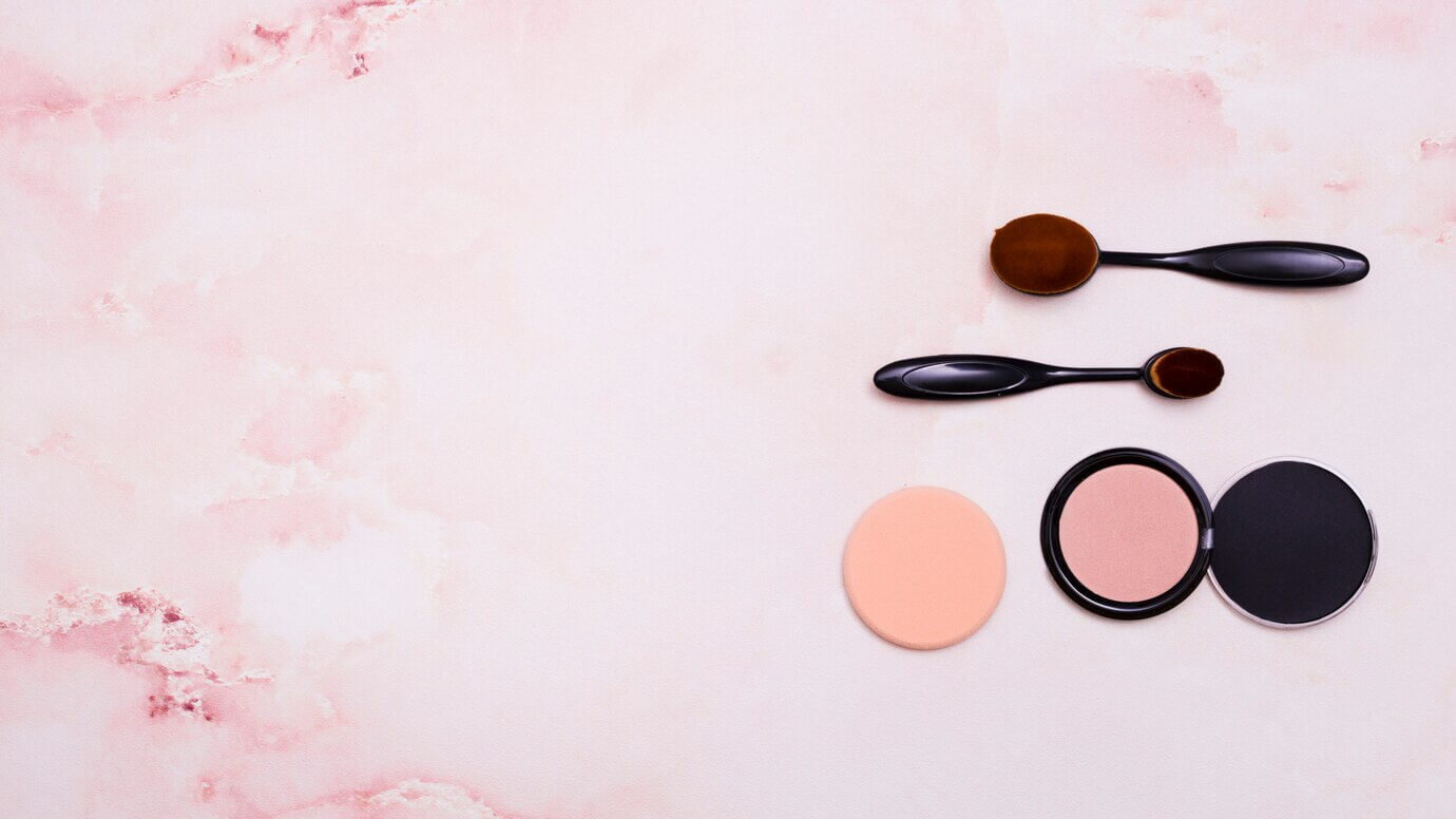 two oval black brushes compact face powder puff pink textured backdrop two oval black brushes compact face powder puff pink textured backdrop